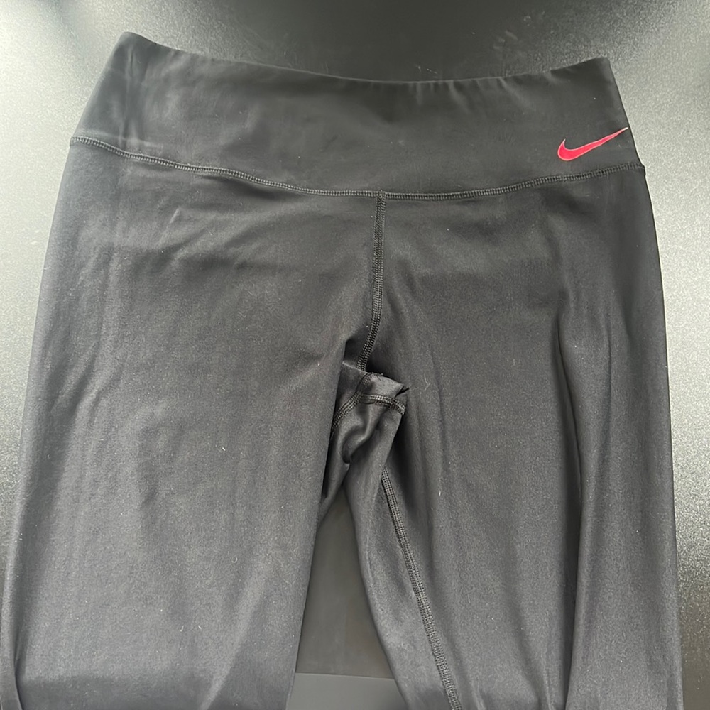 Black with one red/white leg Nike leggings.